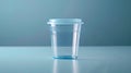 Transparent empty urine analysis container with a blue lid. Clear specimen cup on blue background. Concept of urinalysis