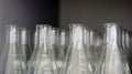 Transparent Erlenmeyer flasks or conical flasks on shelf in science laboratory, use for measuring solvent or solution. Royalty Free Stock Photo