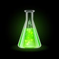 Transparent flask with magic green liquid on black Royalty Free Stock Photo