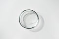 Transparent gel with air bubbles in glass petri dish on white background. Concept laboratory tests and research