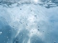 De-focused blurred transparent blue colored clear calm water surface texture with splashes and bubbles. Trendy abstract nature Royalty Free Stock Photo