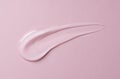 Transparent gel drop on pink background. Liquid gel cosmetic stain texture. Beauty serum drop