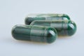 Transparent gelatin capsules with spirulina powder,