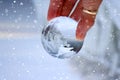 Transparent glass ball reflecting a frozen winter lake