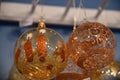 Transparent glass bulbs with golden frosty pattern and hand painted candles. Fairytale Christmas tree ornaments closeup. Royalty Free Stock Photo