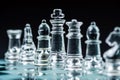 Transparent glass chess pieces on dark background. Leadership and strategy concept, selective focus Royalty Free Stock Photo