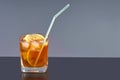 Transparent glass with cold tea, ice, lemon and cocktail tubule Royalty Free Stock Photo