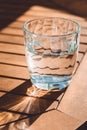 A transparent glass of crystal clean water on the wooden table Royalty Free Stock Photo