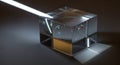 A transparent glass cube prism sits on a surface with a beam of white light entering it from the Royalty Free Stock Photo