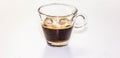 A transparent glass cup with creamy espresso, the cream of the coffee is a roasted brown and resembles the beans of the toasted co Royalty Free Stock Photo