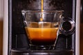 A transparent glass cup with creamy espresso, the cream of the coffee is a roasted brown and resembles the beans of the toasted co Royalty Free Stock Photo