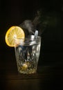 Transparent glass cup with swell the boiling water into it. The vapor from the top. Black background. Royalty Free Stock Photo