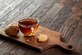 Cup of tea with cookies on a cutting board on a wooden background, top view Royalty Free Stock Photo