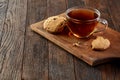 Cup of tea with cookies on a cutting board on a wooden background, top view Royalty Free Stock Photo