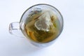 A transparent glass cup of tea of herbal tea in a bag on a white background top view Royalty Free Stock Photo