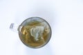 A transparent glass cup of tea of herbal tea in a bag on a white background top view Royalty Free Stock Photo