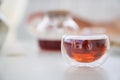 Transparent glass Cup of tea in nature. The concept of breakfast in the backyard of the house. Early morning, tea and Royalty Free Stock Photo