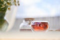 Transparent glass Cup of tea in nature. The concept of breakfast in the backyard of the house. Early morning, tea and Royalty Free Stock Photo