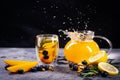 Transparent glass cup and teapot with fruit tea, on a black and gray background Royalty Free Stock Photo