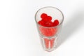 Transparent glass with delicious red dried cherries. White background. Dried fruits healthy eating