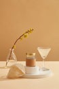 A transparent glass filled with bird nest soup standing next to a jar placed on podium, Royalty Free Stock Photo