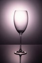 Transparent  glass goblet without wine on a thin leg stands  on a mirror surface Royalty Free Stock Photo