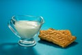 Transparent glass gravy boat with milk and cookies close-up Royalty Free Stock Photo