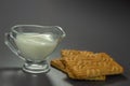 Transparent glass gravy boat with milk and cookies close-up Royalty Free Stock Photo