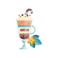 Glass of hot coffee drink with creamy foam. Cup of delicious beverage with sweet candy cane. Orange flower and green