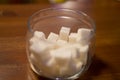 Transparent glass jar with white sugar on the table