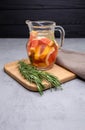 A transparent glass jug with grapefruit wedges and rosemary Royalty Free Stock Photo