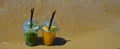 a glass of lemonade with a straw on the seashore, a sunny beach, summer vacation. background for the design. Royalty Free Stock Photo