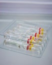 Transparent glass medical ampoules in cardboard packaging. Ampoules with medicine for injection.