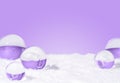 Transparent glass orbs with white snow on lavender background.