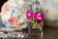 Transparent glass perfume bottle with crimson ribbon