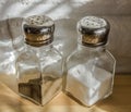 Transparent glass saltcellars with salt and pepper Royalty Free Stock Photo