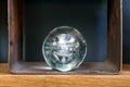 Transparent glass sphere or orb displayed on a shelf Royalty Free Stock Photo