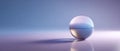 Transparent glass sphere reflecting soft pastel light on smooth surface with subtle shadow and gradient background Royalty Free Stock Photo