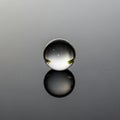 Transparent glass sphere rests on a reflective surface, showcasing Royalty Free Stock Photo