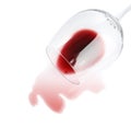 Transparent glass and spilled exquisite red wine on white background