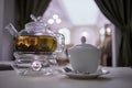 Transparent glass teapot on candle heater and Royalty Free Stock Photo