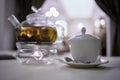 Transparent glass teapot on candle heater and Royalty Free Stock Photo