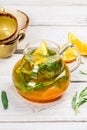 Transparent glass teapot with mango flavored tea Royalty Free Stock Photo