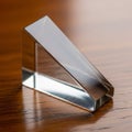 Transparent glass triangular prism displayed on a polished wooden Royalty Free Stock Photo