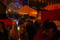 Girl Holding a Sparkly Helium Balloon at Night. Royalty Free Stock Photo