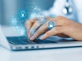 Transparent holographic interface with hexagonal security elements over hands typing, symbolizing futuristic biometric security
