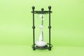 Transparent hourglass, Green background. In the center. Copy, text space