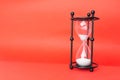 Transparent hourglass, Red background. On the right. Copy, text space Royalty Free Stock Photo