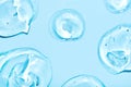 Transparent hyaluronic acid gel on a blue background.