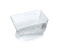 Transparent ice cube melting on white